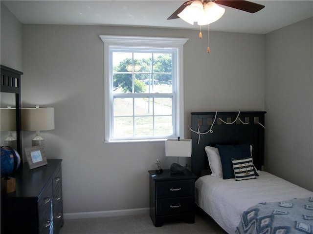 bedroom featuring ceiling fan and carpet