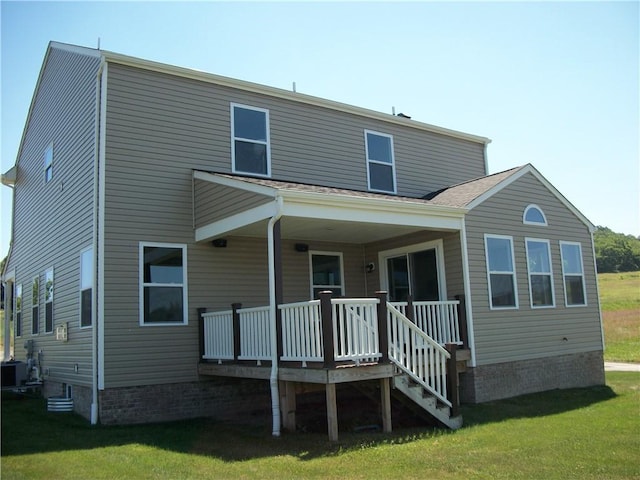 rear view of house with a yard