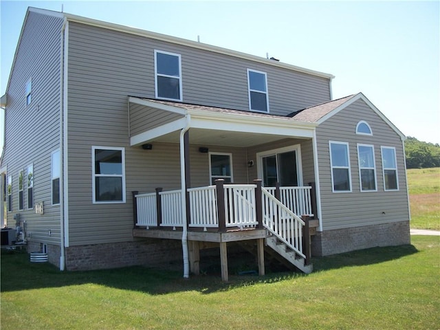 rear view of house featuring a yard