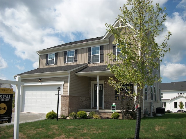 craftsman-style home featuring a garage, a front yard, and central AC unit