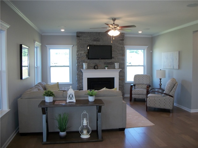 living room with ceiling fan, a fireplace, dark hardwood / wood-style flooring, and crown molding