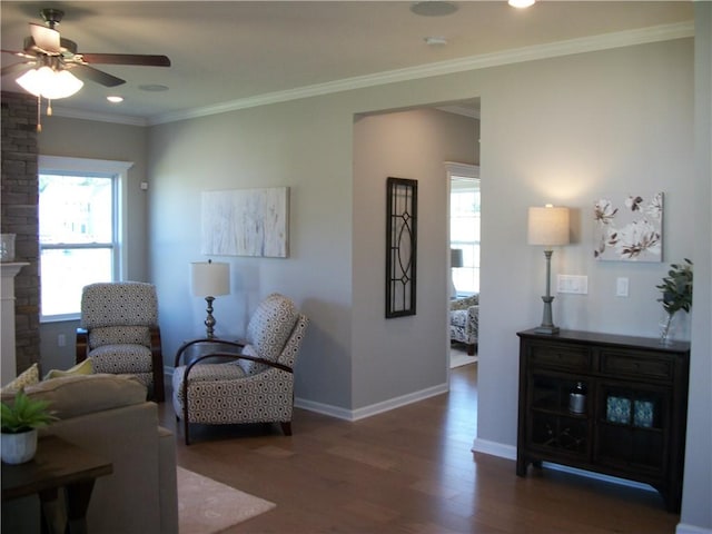 living area featuring ornamental molding, dark hardwood / wood-style floors, and ceiling fan