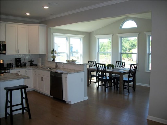 kitchen featuring tasteful backsplash, white cabinetry, dishwasher, sink, and light stone counters