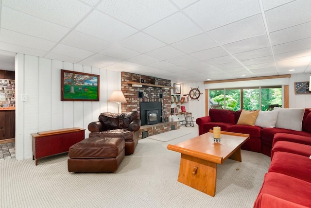 carpeted living room with a paneled ceiling