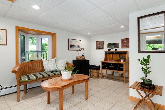 sitting room featuring a paneled ceiling and light tile patterned floors