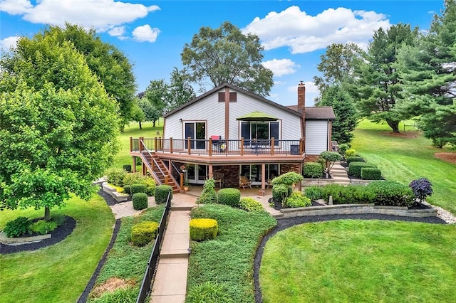 rear view of house with a yard and a deck