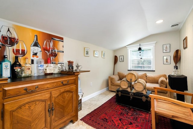 living room featuring vaulted ceiling and bar area