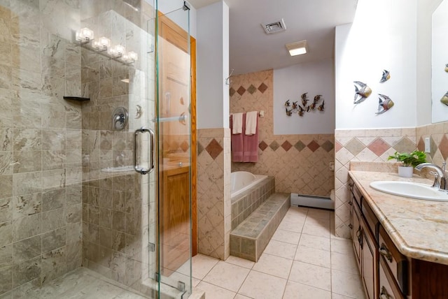 bathroom with baseboard heating, tile patterned flooring, tile walls, vanity, and shower with separate bathtub