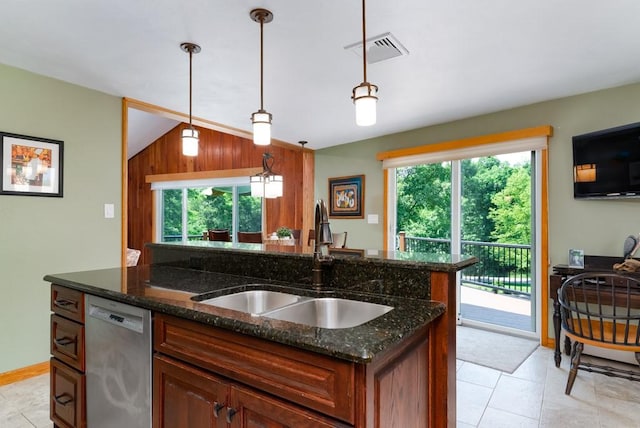 kitchen featuring decorative light fixtures, dishwasher, sink, and dark stone countertops