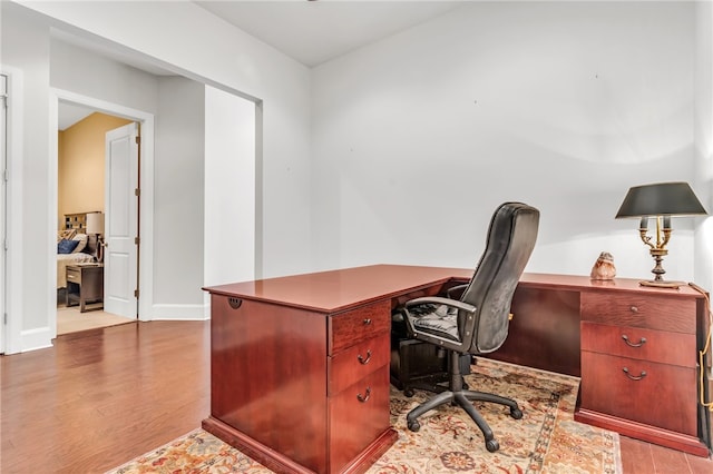 office featuring light hardwood / wood-style floors and built in desk