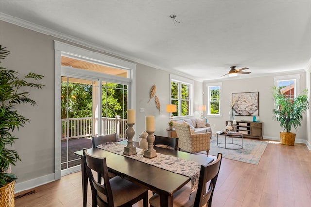 dining room featuring crown molding, ceiling fan, and light hardwood / wood-style floors