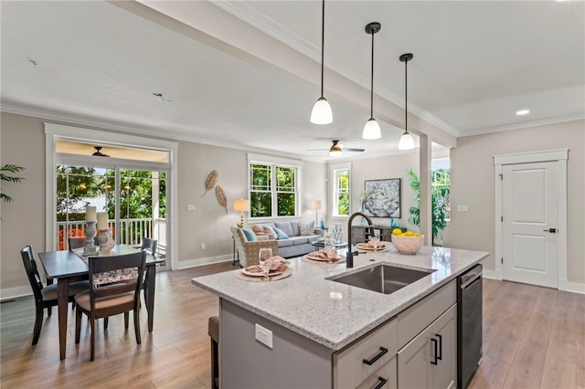 kitchen with hanging light fixtures, sink, ceiling fan, and hardwood / wood-style flooring