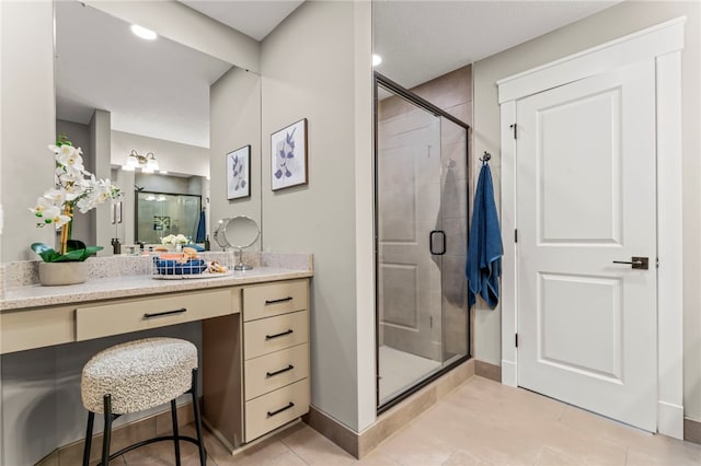 bathroom featuring vanity, walk in shower, and tile patterned flooring