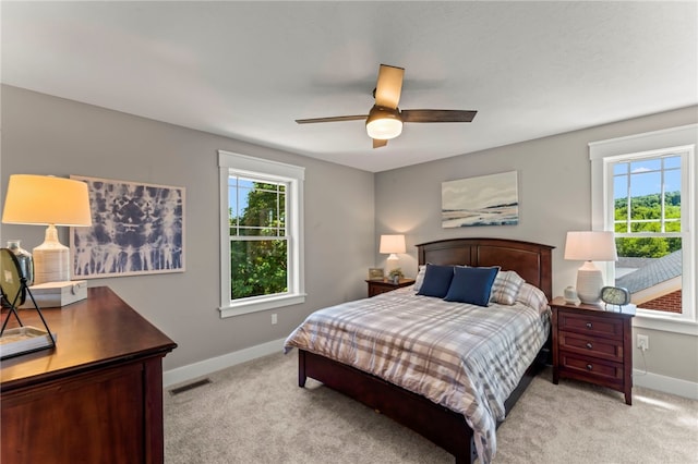 bedroom featuring light colored carpet and ceiling fan