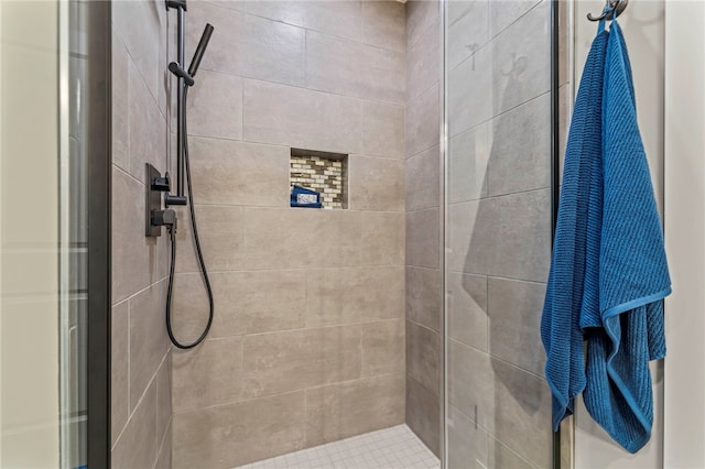 bathroom with a tile shower