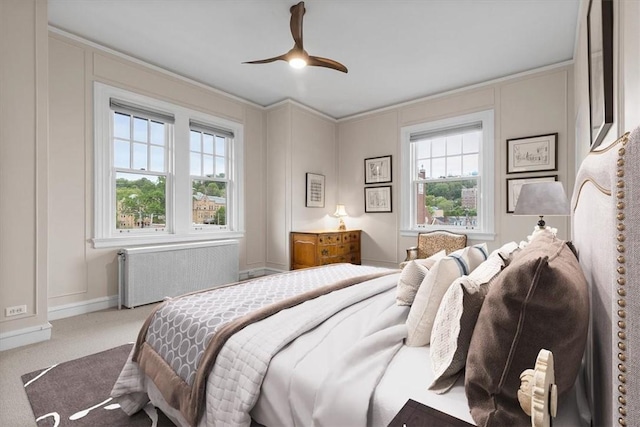 carpeted bedroom with ceiling fan, ornamental molding, and radiator heating unit