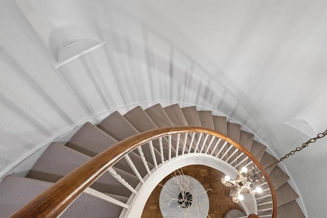 stairway with a chandelier