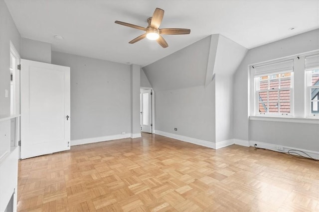 additional living space featuring lofted ceiling, ceiling fan, and light parquet floors