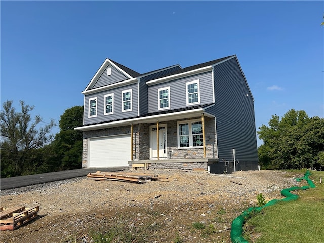 view of front of property featuring a garage and covered porch