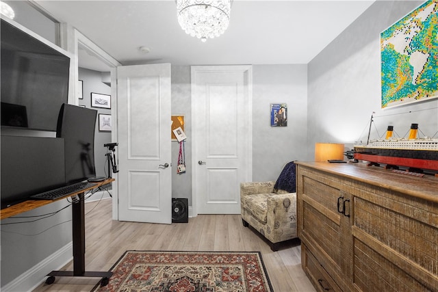 interior space featuring light wood-type flooring and a chandelier