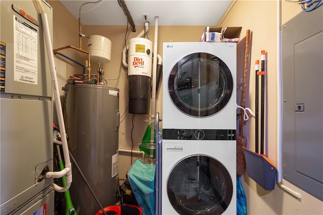 laundry area featuring stacked washer / dryer, heating unit, and water heater