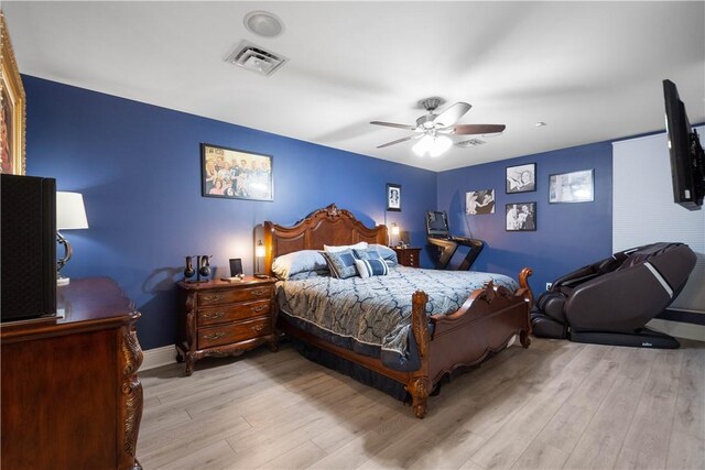 bedroom with light hardwood / wood-style floors and ceiling fan