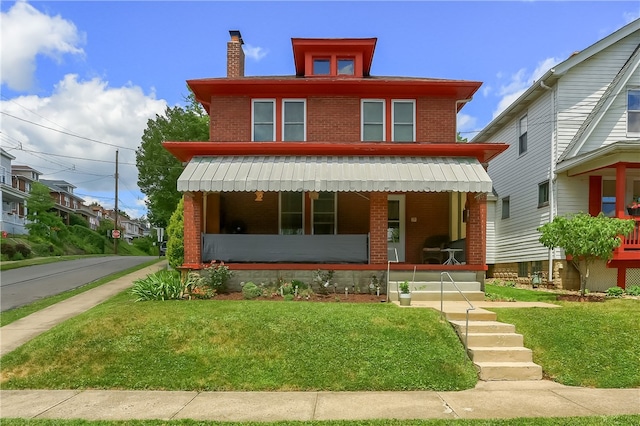 view of front facade featuring a porch and a front lawn