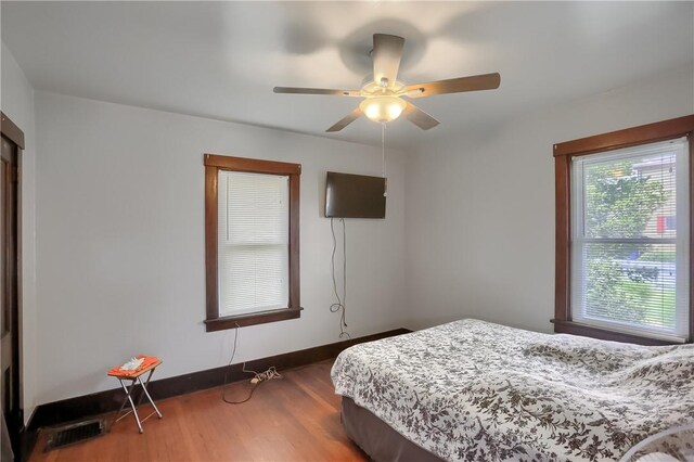 bedroom with ceiling fan and hardwood / wood-style floors