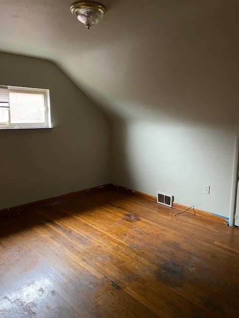 bonus room featuring vaulted ceiling and hardwood / wood-style floors