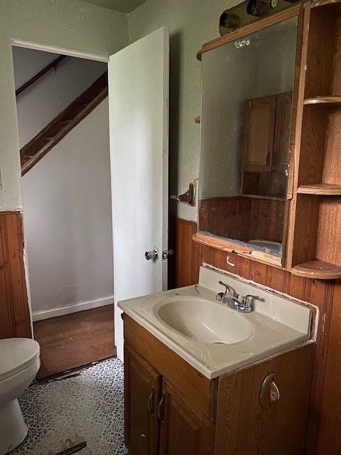 bathroom featuring vanity, hardwood / wood-style flooring, and toilet