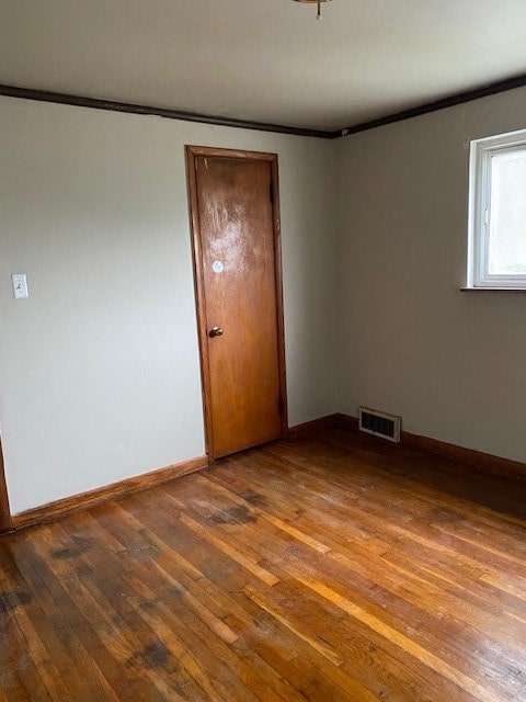 empty room with hardwood / wood-style floors