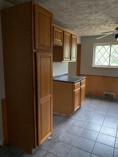 kitchen featuring light tile patterned floors and ceiling fan