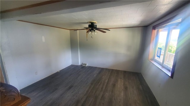 spare room featuring ceiling fan, dark wood-type flooring, and crown molding