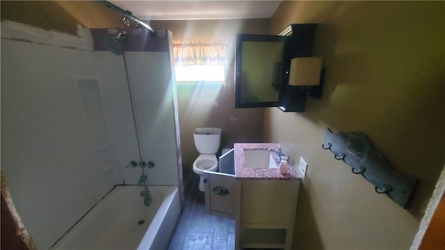 full bathroom with toilet, bathing tub / shower combination, hardwood / wood-style flooring, and vanity