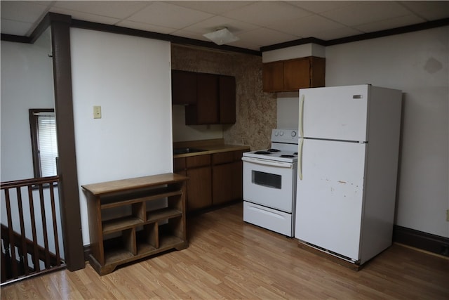 kitchen featuring a drop ceiling, dark brown cabinetry, white appliances, and light wood-type flooring