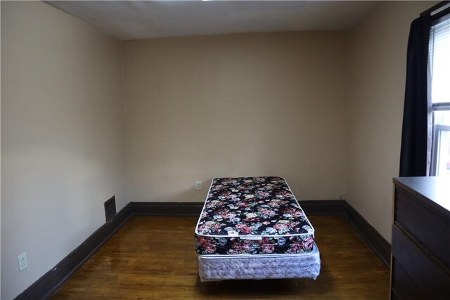 bedroom featuring dark wood-type flooring