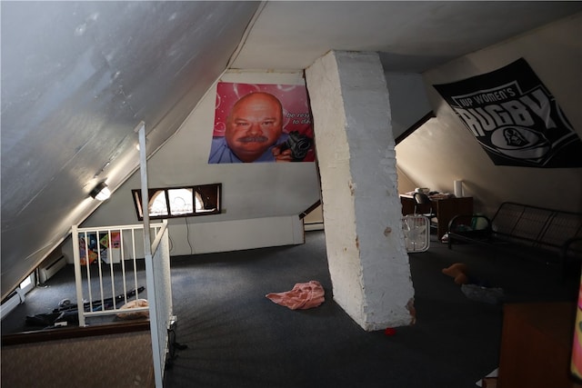 additional living space with dark colored carpet and vaulted ceiling