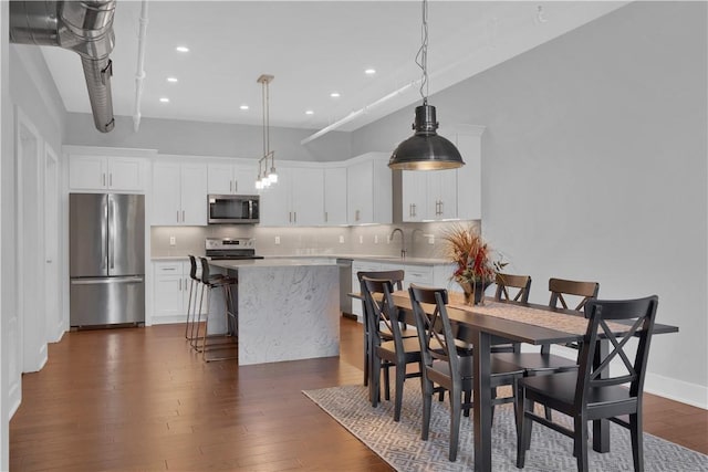 dining space featuring dark hardwood / wood-style floors and sink