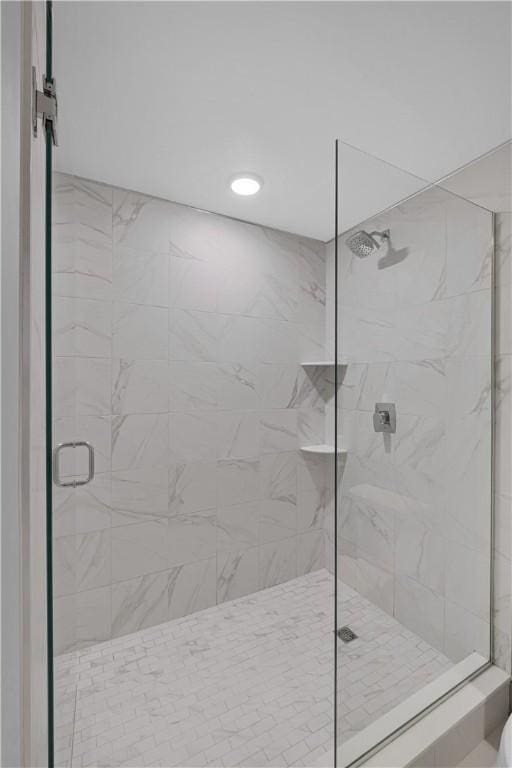 bathroom featuring a shower with shower door