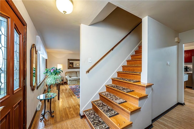 entryway with a healthy amount of sunlight and light hardwood / wood-style flooring