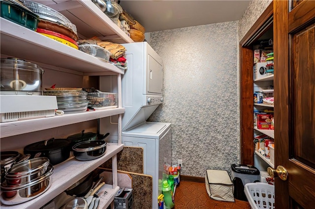 washroom featuring stacked washer / dryer