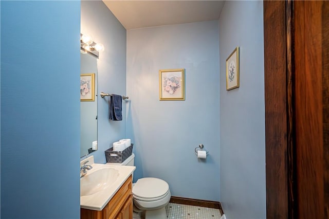 bathroom featuring toilet, vanity, and tile patterned flooring