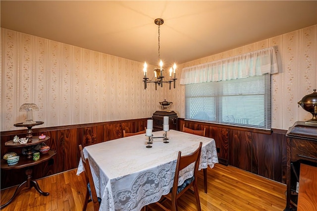 dining area featuring hardwood / wood-style floors and a notable chandelier