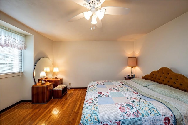 bedroom with ceiling fan and hardwood / wood-style flooring