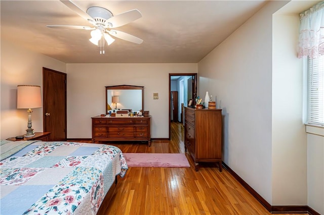 bedroom with ceiling fan and light hardwood / wood-style floors