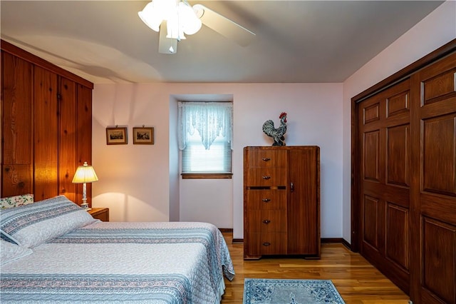 bedroom with ceiling fan, a closet, and light hardwood / wood-style flooring