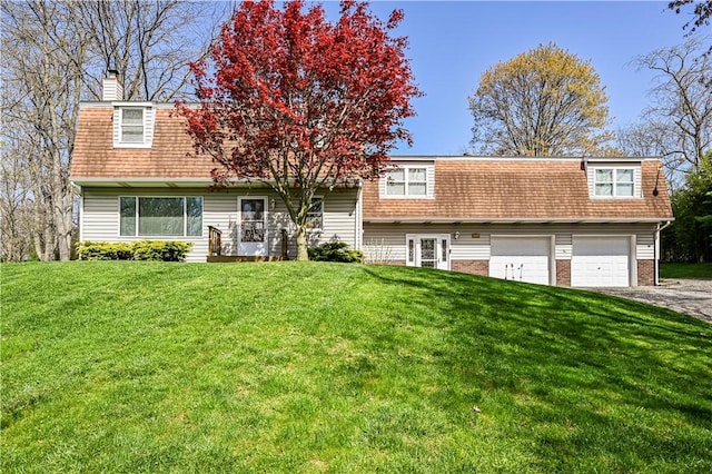 view of front facade with a garage and a front yard