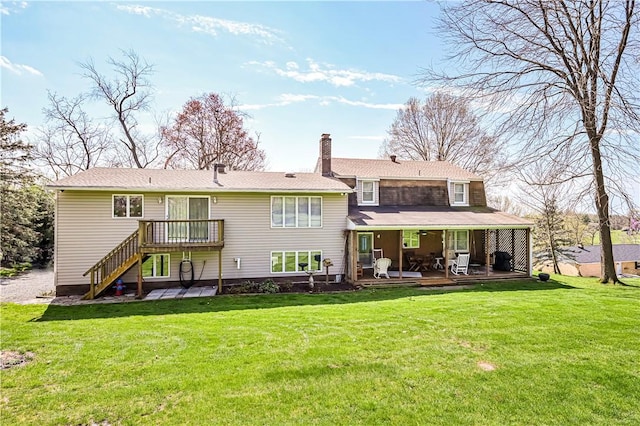 rear view of house with a patio area and a lawn