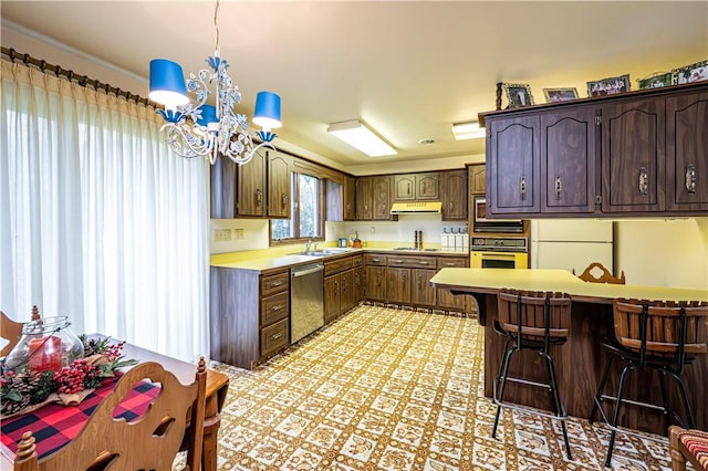 kitchen featuring dishwasher, sink, wall oven, a chandelier, and a breakfast bar area