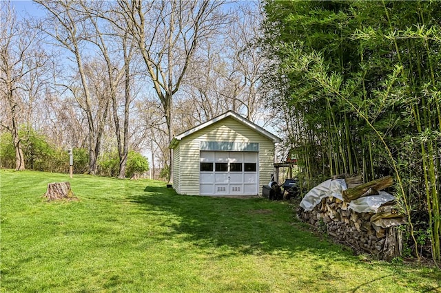 view of yard with a garage and an outbuilding